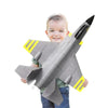 Child holding a toy airplane with a white background